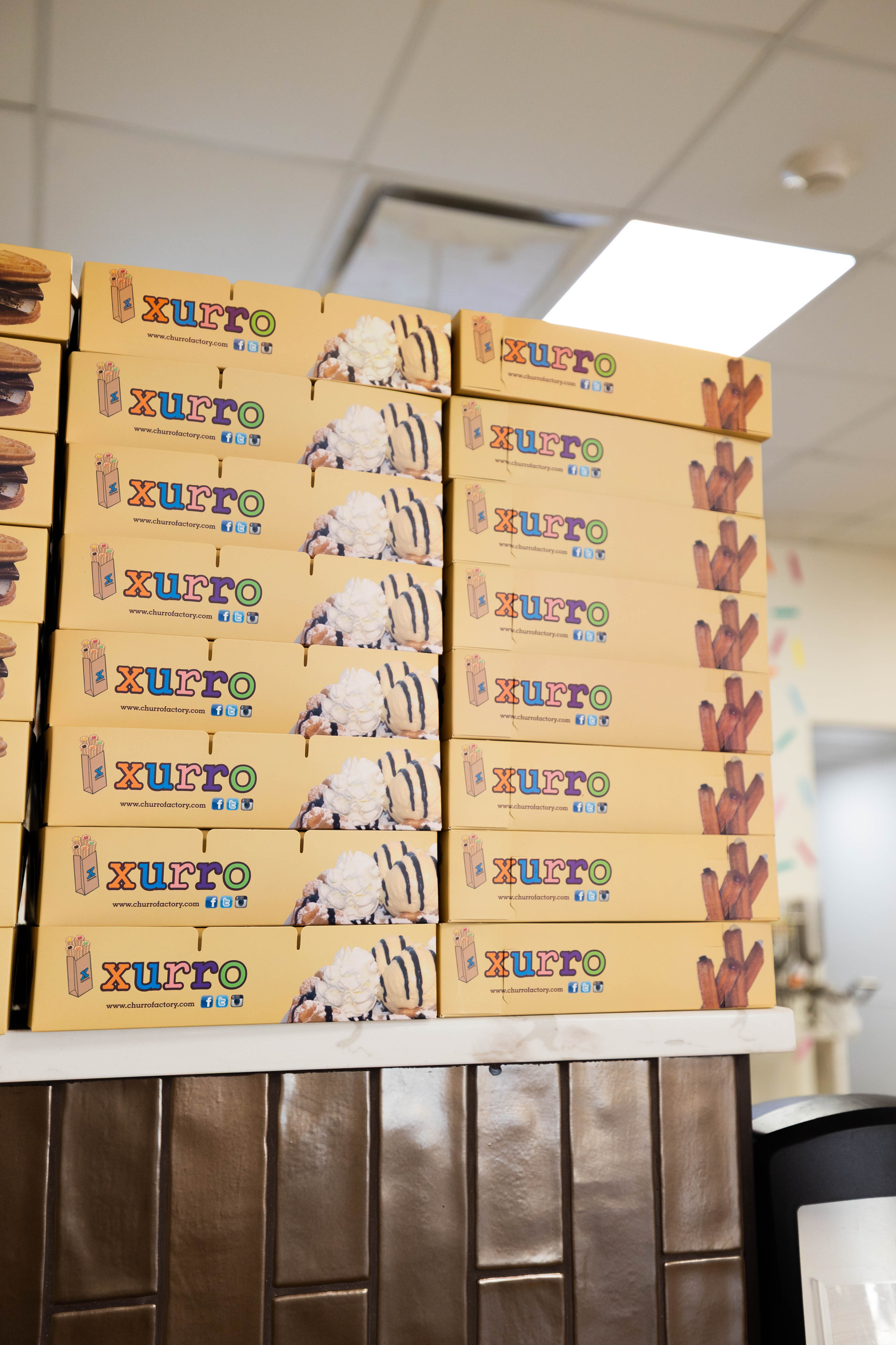 Wholesale churros in stacked to-go boxes